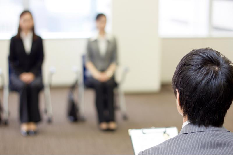 Two people in an office waiting for a job interview.